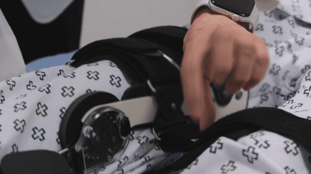 Doctor putting knee brace on patient