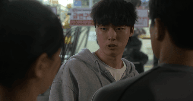 Young man talking to couple at night