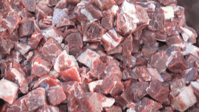 Chunks of raw meat in a container