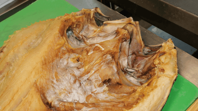 Dried rockfish on green cutting board