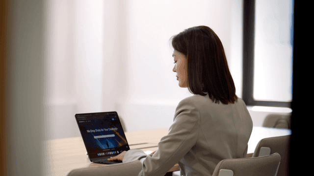 Working woman working on laptop in conference room
