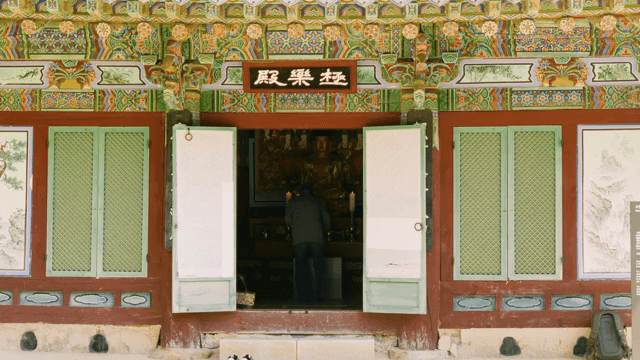 Person praying inside a traditional temple