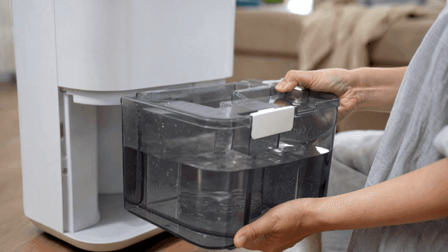 Removing water tank from a dehumidifier