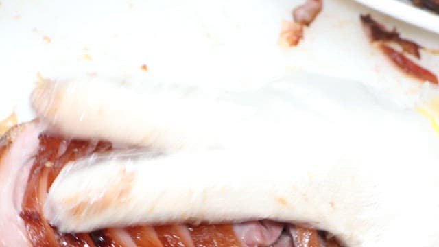 식당 주방에서 먹음직스러운 족발을 접시에 담는 모습