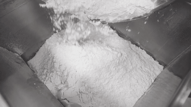 Flour being poured into a mixing bowl