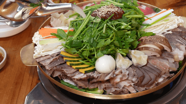 Boiled beef slices hot pot with vegetables and broth