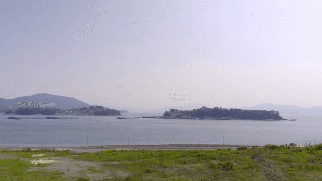 A tranquil seaside view with distant islands