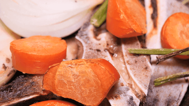 Carrots and onions with meat bones
