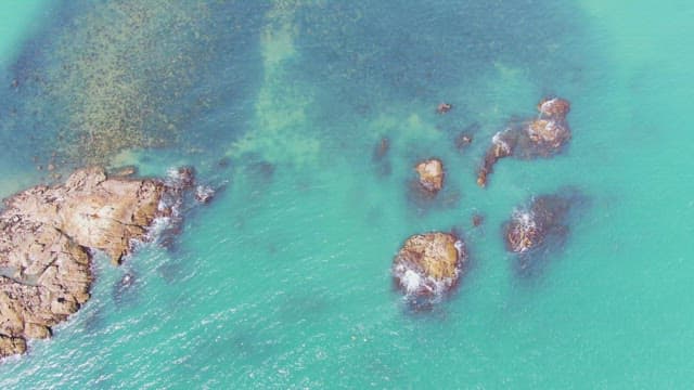 Clear turquoise sea with rocky outcrops