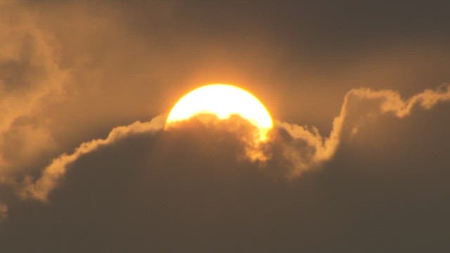Sun through the clouds in the twilight sky