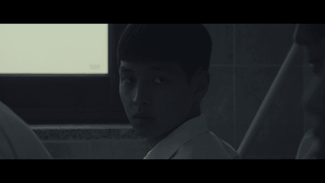 Male student looking back holding mop