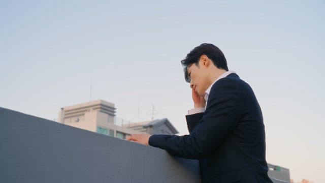 Man in a suit on a rooftop