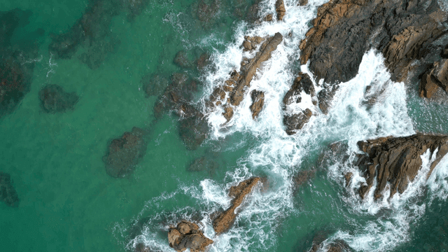Waves crashing on rocky shoreline