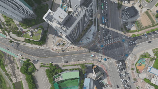 A bustling city intersection with tall buildings
