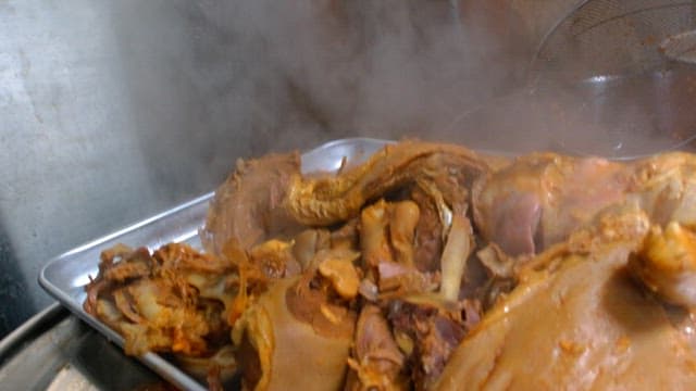 Steaming pig's feets on a metal tray