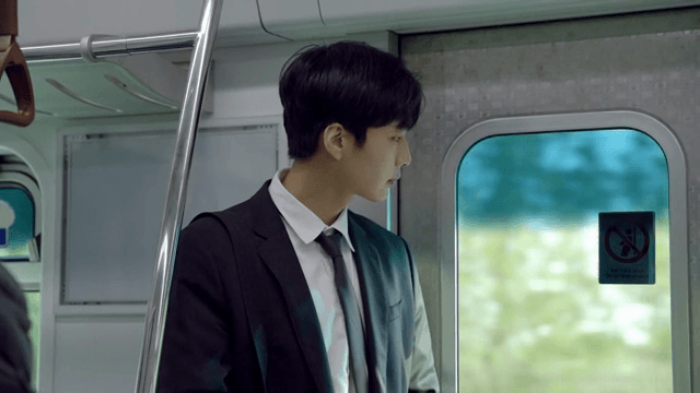 Office worker riding the subway while looking out the window