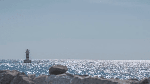Lighthouse by the shimmering sea