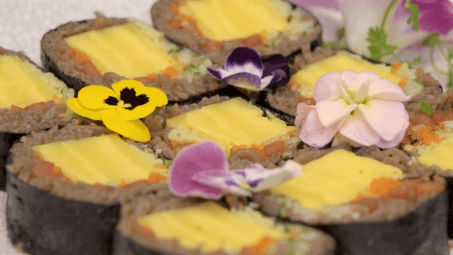 Colorful sushi rolls garnished with flowers