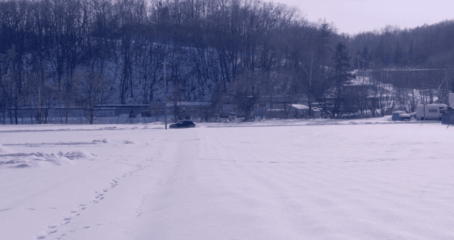 차가 달리는 눈 덮인 숲 도로