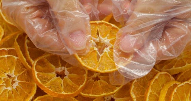 Hand Showing Marketability of Dried Orange Slices