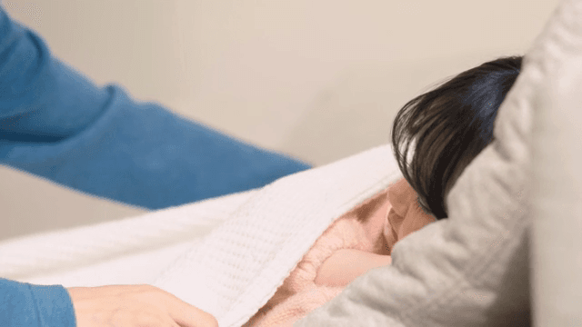 아빠가 잠든 아이에게 이불을 덮어주는 모습