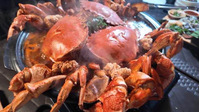 Yellow crab soup boiling in pot