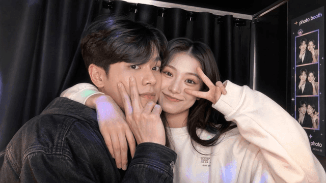 Couple happily posing in photo booth