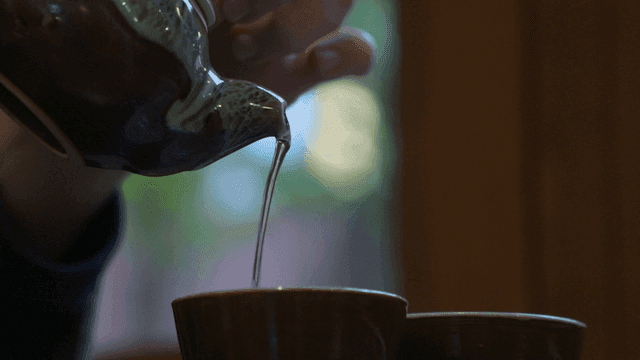 Pouring tea into cup