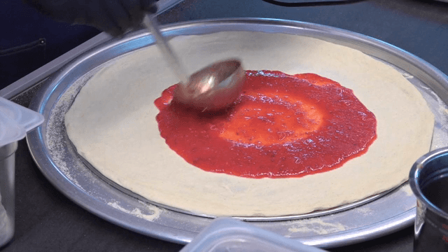 피자 도우에 토마토 소스 바르기