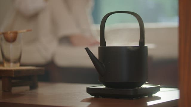 Person Waiting for the Water to Boil for Brewing Tea