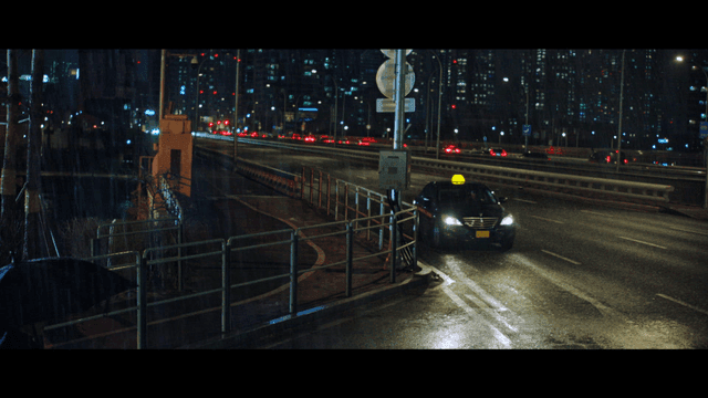 Road on city bridge on rainy night