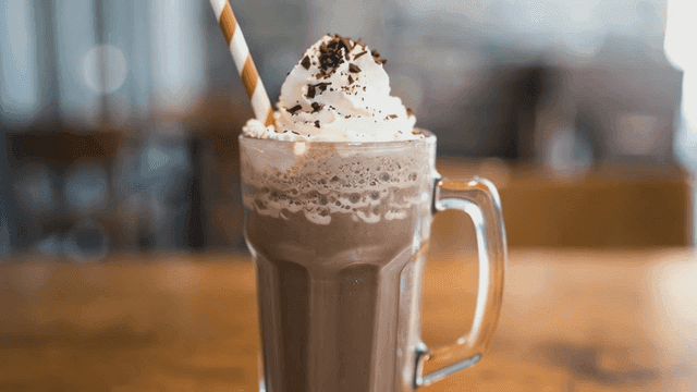 Cream chocolate milkshake on table