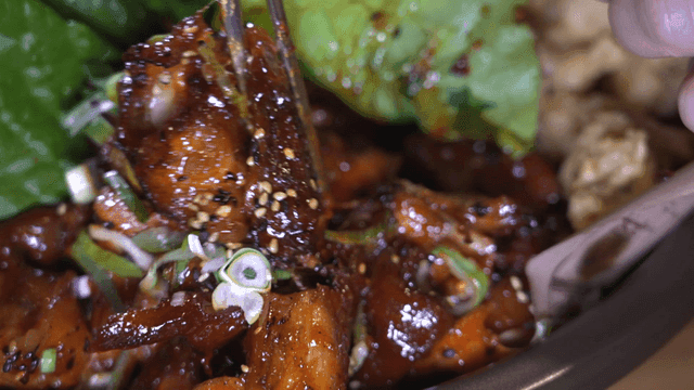 Chopsticks for picking up spicy pig's trotters sprinkled with sesame seeds