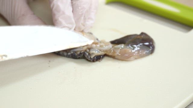 Preparing abalone on a kitchen board