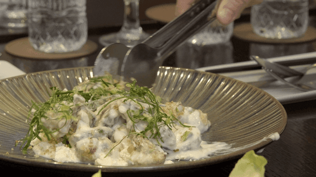 Creamy dish mixed with tongs