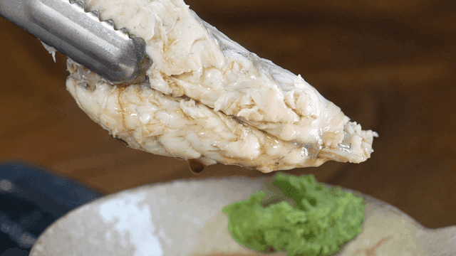 Clear pufferfish soup dipped in soy sauce with wasabi
