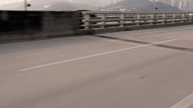 Empty highway with city skyline in view
