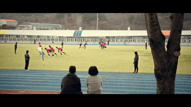Rugby match on field with parents present
