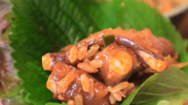 Spicy octopus and rice on lettuce wrap