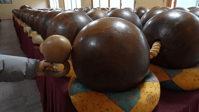Wooden bell and giant prayer beads