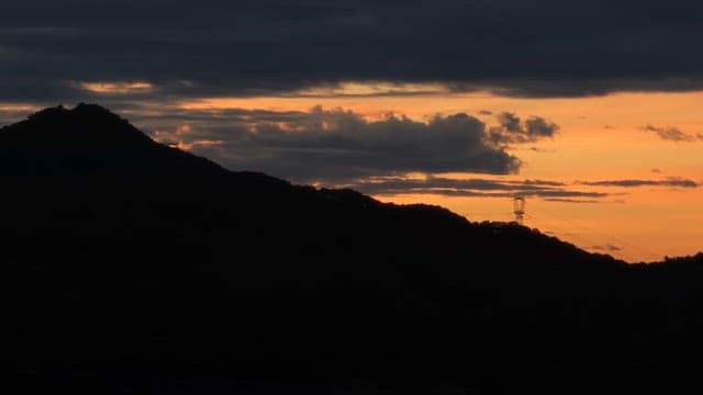 Sunset over a mountain with clouds