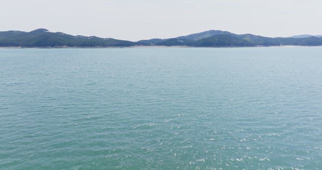 Calm sea with distant mountains