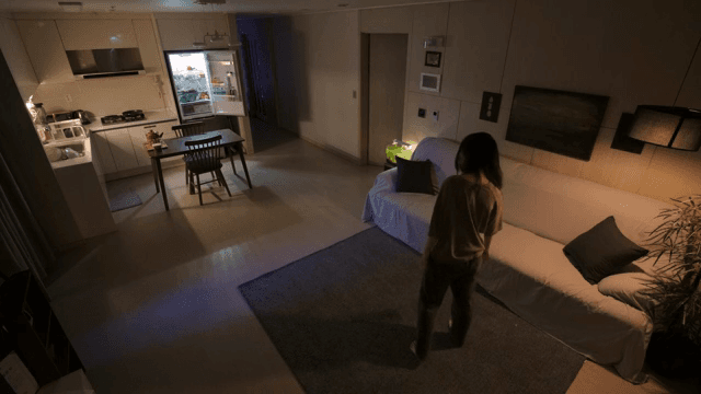 어두운 거실을 돌아다니는 여성