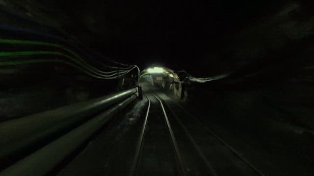 A journey through an underground mine on a railway track