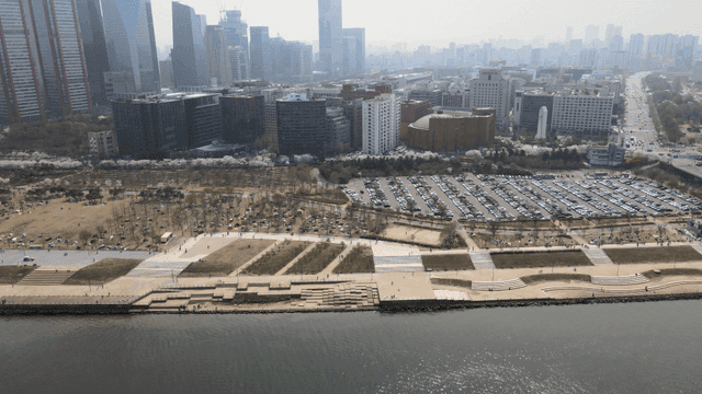 Riverside park with view of downtown high-rise buildings