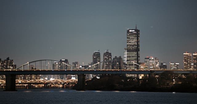 Illuminated bridge and city view under night sky