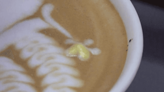 Latte art being created in a coffee cup