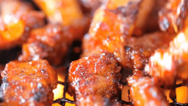 Grilled Pork Belly with spicy sauce on the grill