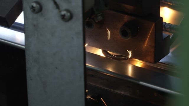 Metal being processed with sparks flying