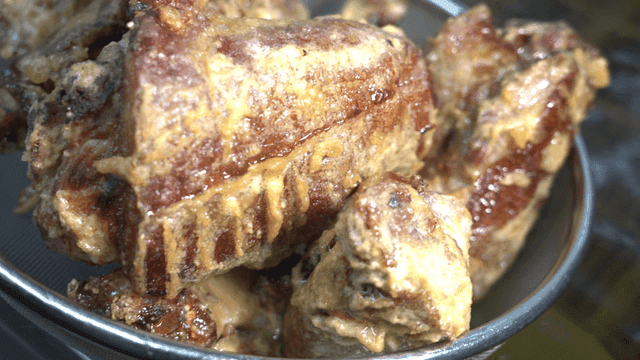 Freshly fried pig's trotters in sieve